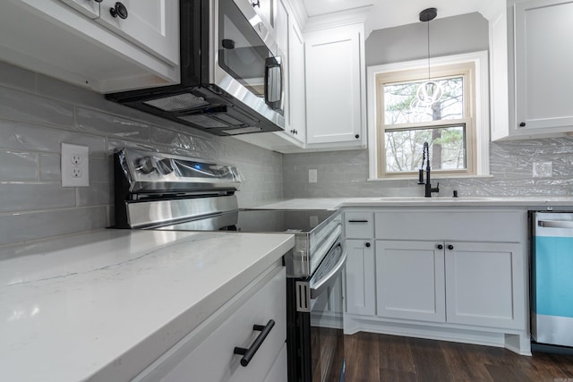 kitchen featuring backsplash, white cabinetry, sink, and stainless steel appliances