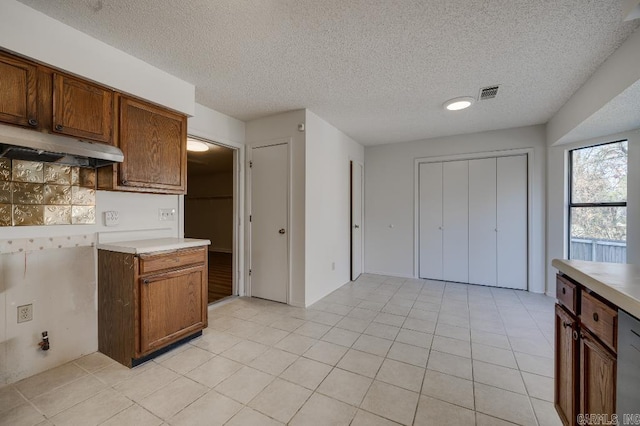 kitchen with light tile patterned flooring and a textured ceiling