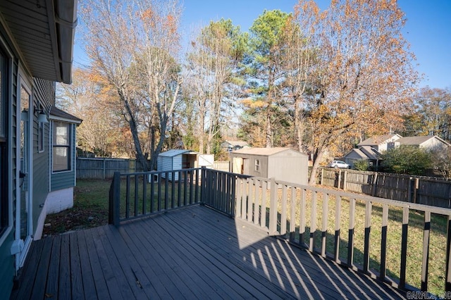 deck with a yard and a shed