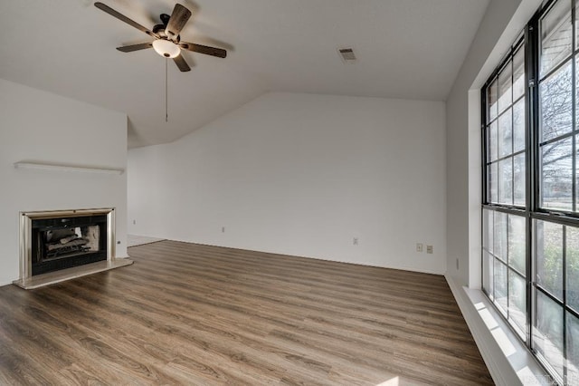 unfurnished living room featuring hardwood / wood-style flooring, vaulted ceiling, and ceiling fan