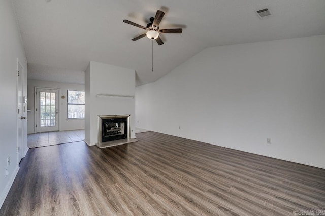 unfurnished living room with ceiling fan, dark wood-type flooring, and vaulted ceiling