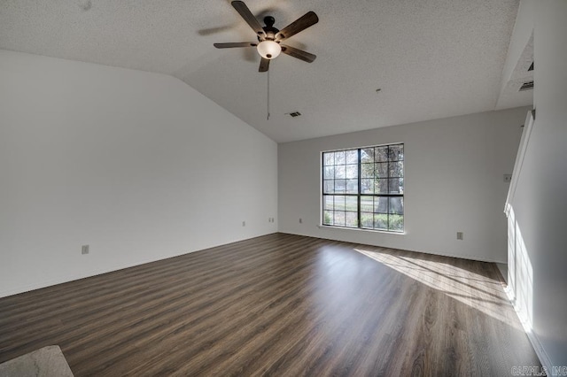 spare room featuring ceiling fan, dark hardwood / wood-style flooring, a textured ceiling, and vaulted ceiling