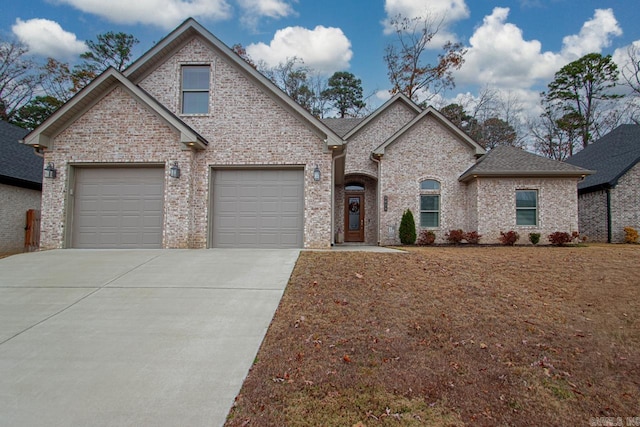 french country style house with a garage