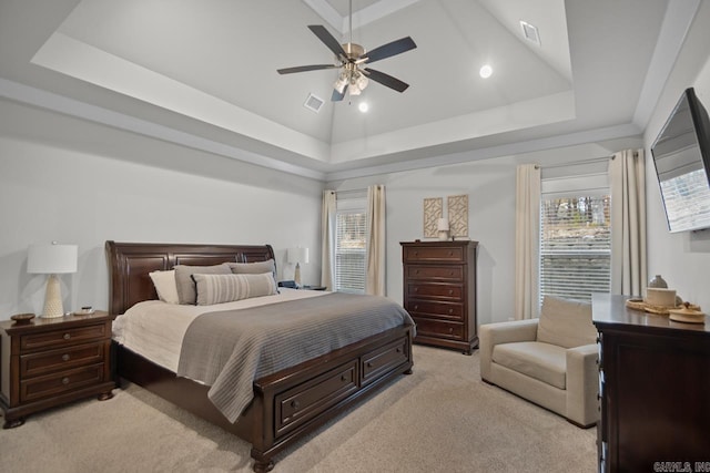 bedroom featuring a tray ceiling, ceiling fan, and light colored carpet