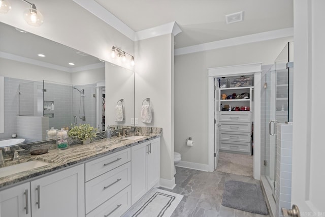 bathroom with vanity, toilet, and an enclosed shower