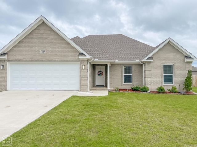 view of front of house featuring a garage and a front lawn