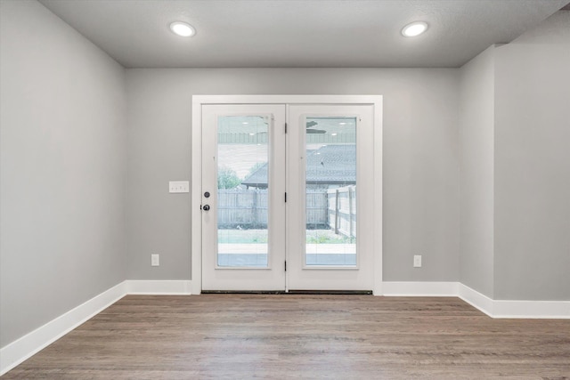 108 Delle Ln, Brookland, AR 72417 - doorway to outside featuring baseboards, recessed lighting, and wood finished floors