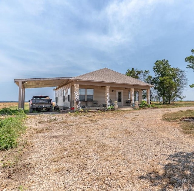 view of front of house with a carport and a porch