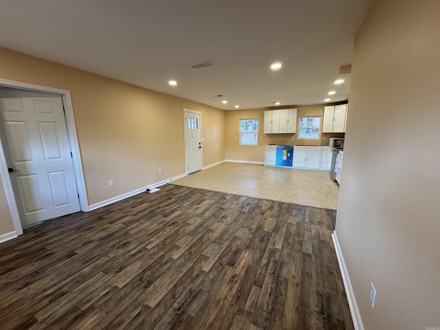 unfurnished living room with dark hardwood / wood-style floors