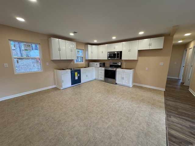 kitchen with white cabinetry and appliances with stainless steel finishes