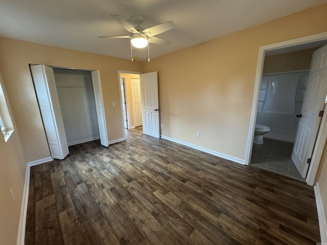 unfurnished bedroom with ensuite bath, ceiling fan, and dark hardwood / wood-style flooring