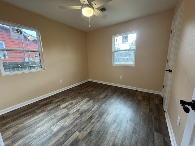 spare room featuring ceiling fan and dark hardwood / wood-style flooring