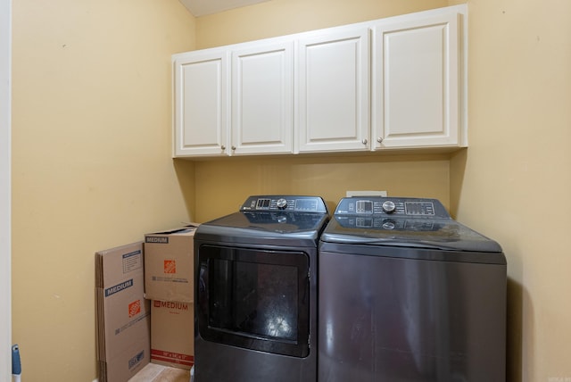 laundry room featuring cabinets and washing machine and dryer