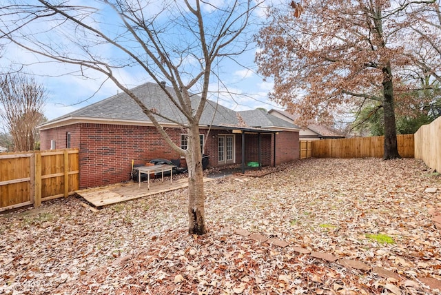 rear view of property featuring french doors and a deck