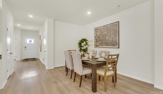 dining space with light hardwood / wood-style flooring