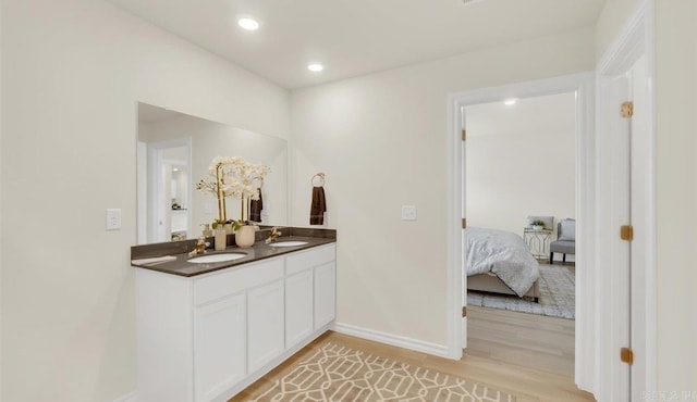 bathroom featuring hardwood / wood-style floors and vanity