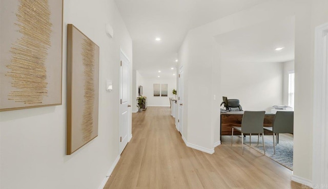 hallway with light hardwood / wood-style floors