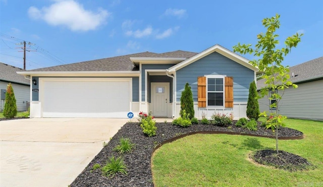 view of front of property with a front yard and a garage