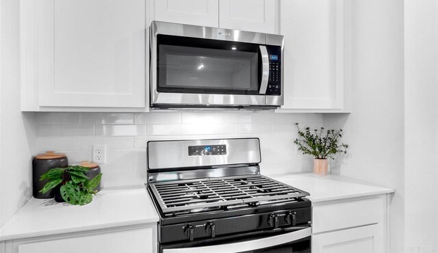 kitchen featuring white cabinetry, appliances with stainless steel finishes, and tasteful backsplash