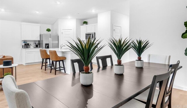 dining space with light hardwood / wood-style floors