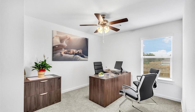 carpeted office space featuring ceiling fan