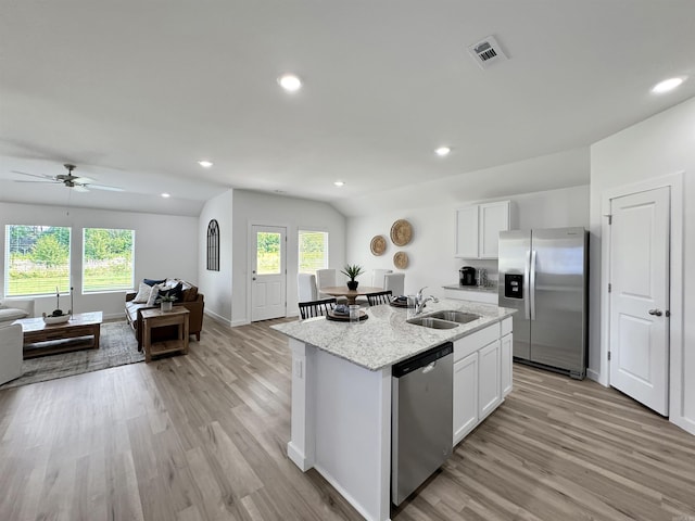 kitchen featuring a kitchen island with sink, sink, white cabinets, and appliances with stainless steel finishes