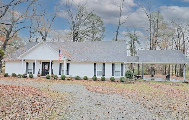 single story home featuring covered porch and a carport