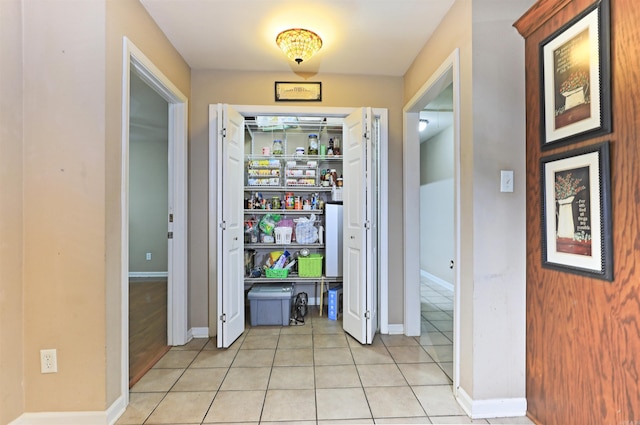 corridor with light tile patterned floors