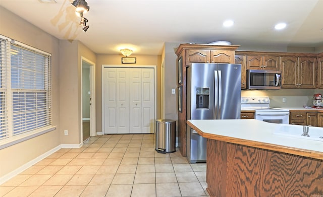 kitchen with light tile patterned floors and appliances with stainless steel finishes