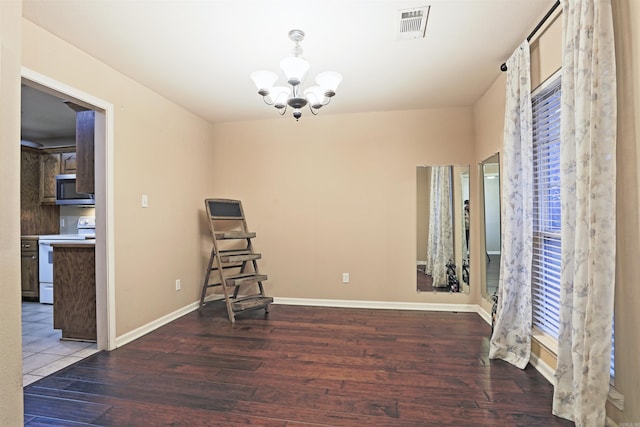 interior space featuring hardwood / wood-style floors and an inviting chandelier