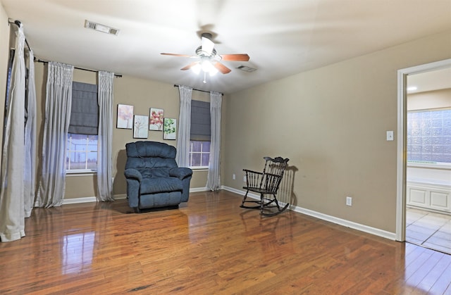 living area with hardwood / wood-style flooring and ceiling fan