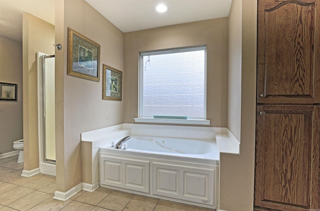 bathroom featuring tile patterned flooring, a healthy amount of sunlight, toilet, and separate shower and tub