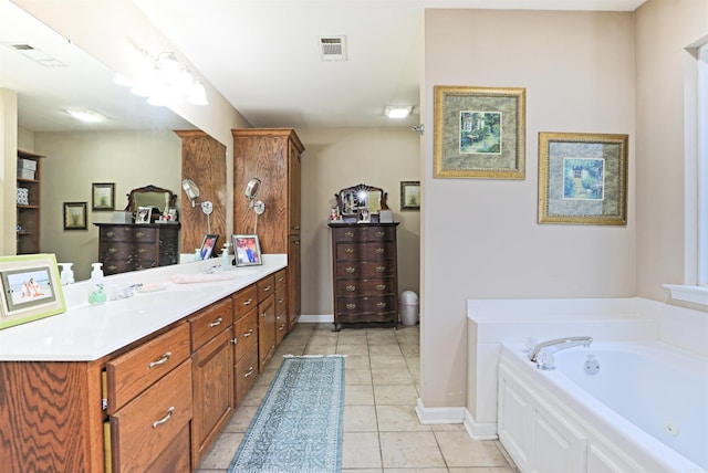 bathroom featuring tile patterned floors, a bathing tub, and vanity