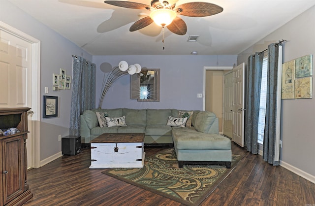 living room featuring ceiling fan and dark hardwood / wood-style flooring