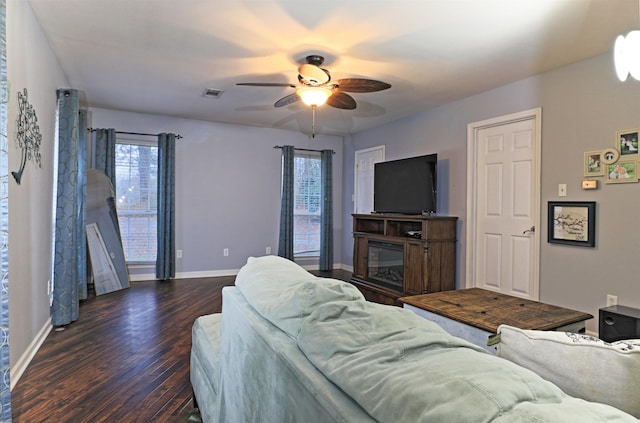 living room featuring dark hardwood / wood-style floors and ceiling fan