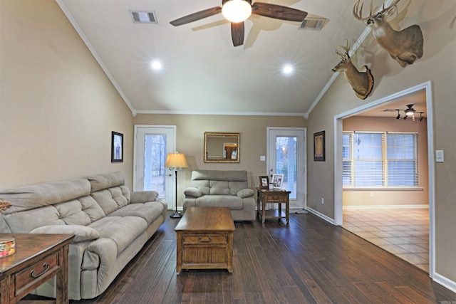 living room featuring ceiling fan, crown molding, lofted ceiling, and dark wood-type flooring