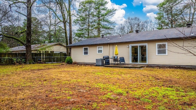 back of house featuring a patio area and a lawn