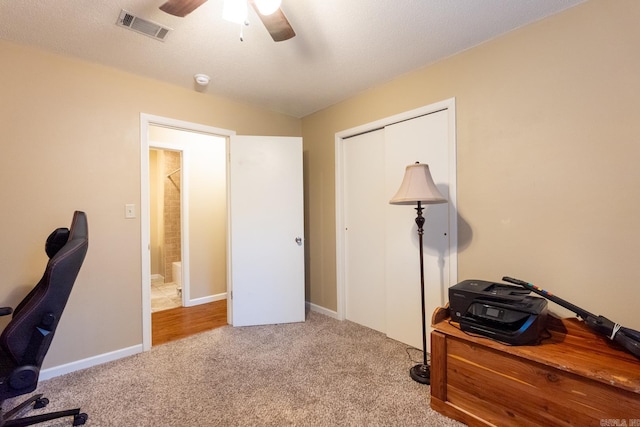 carpeted home office with ceiling fan