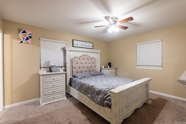 bedroom featuring ceiling fan, light colored carpet, and a textured ceiling