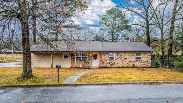 ranch-style home with a front yard