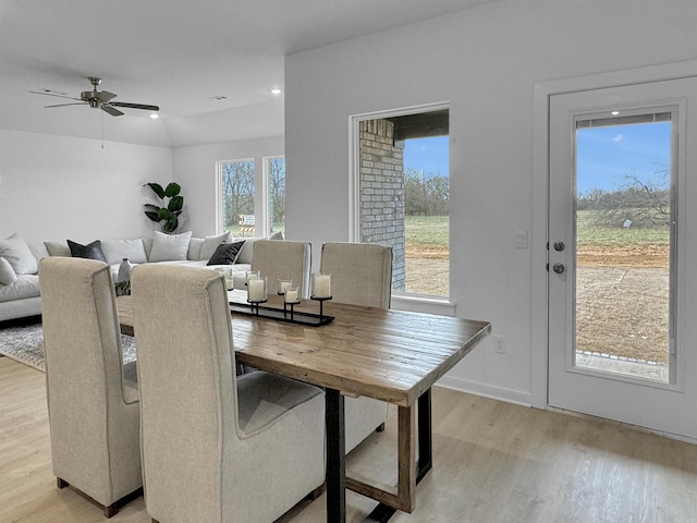 dining room with vaulted ceiling, light hardwood / wood-style flooring, and ceiling fan