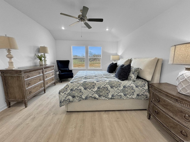 bedroom featuring light hardwood / wood-style floors, ceiling fan, and lofted ceiling