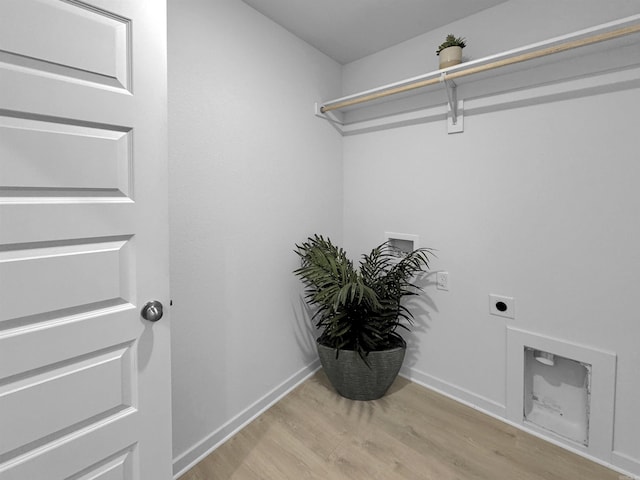 washroom featuring hookup for a washing machine, light hardwood / wood-style flooring, and hookup for an electric dryer