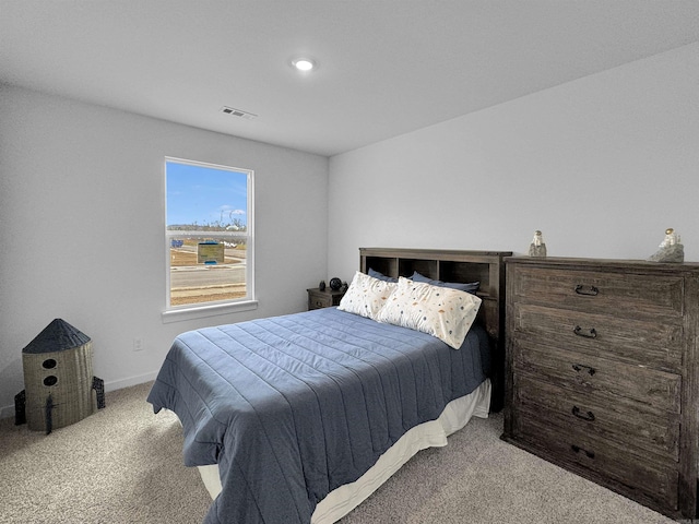 bedroom featuring light colored carpet