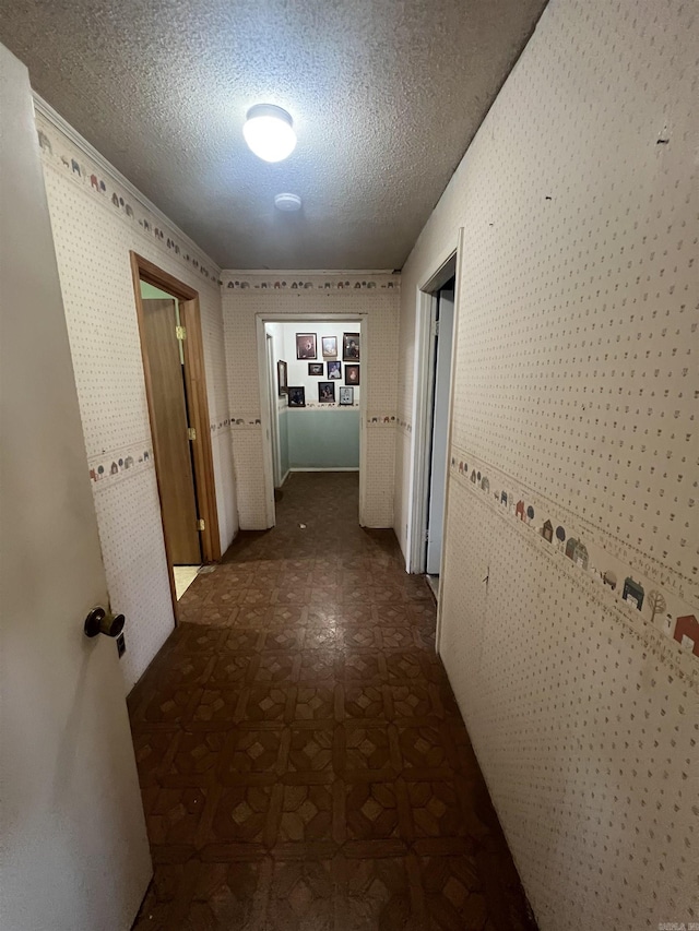 hallway with a textured ceiling