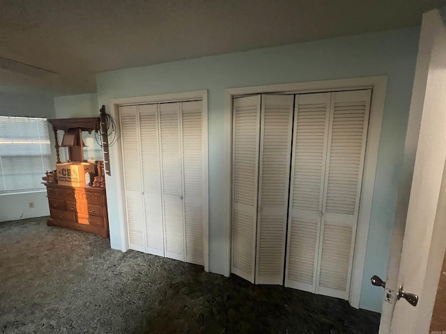 unfurnished bedroom featuring multiple closets