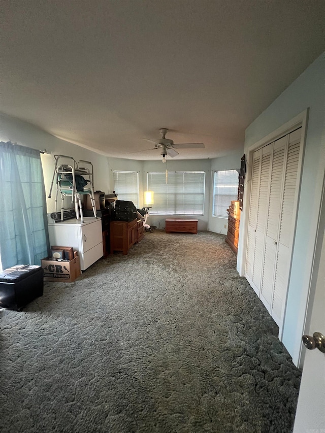 unfurnished bedroom featuring carpet floors, a closet, and ceiling fan