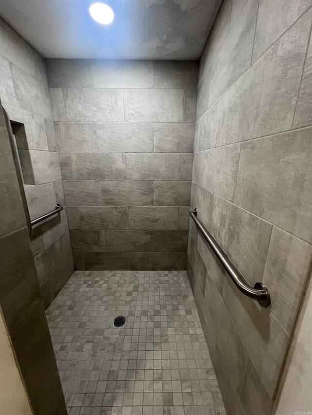 bathroom with a tile shower