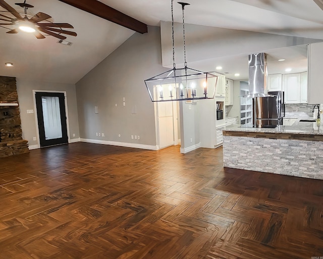 kitchen featuring sink, tasteful backsplash, beamed ceiling, island exhaust hood, and white cabinets