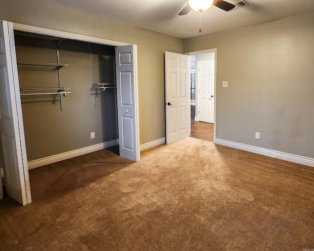 unfurnished bedroom with ceiling fan, a closet, and carpet